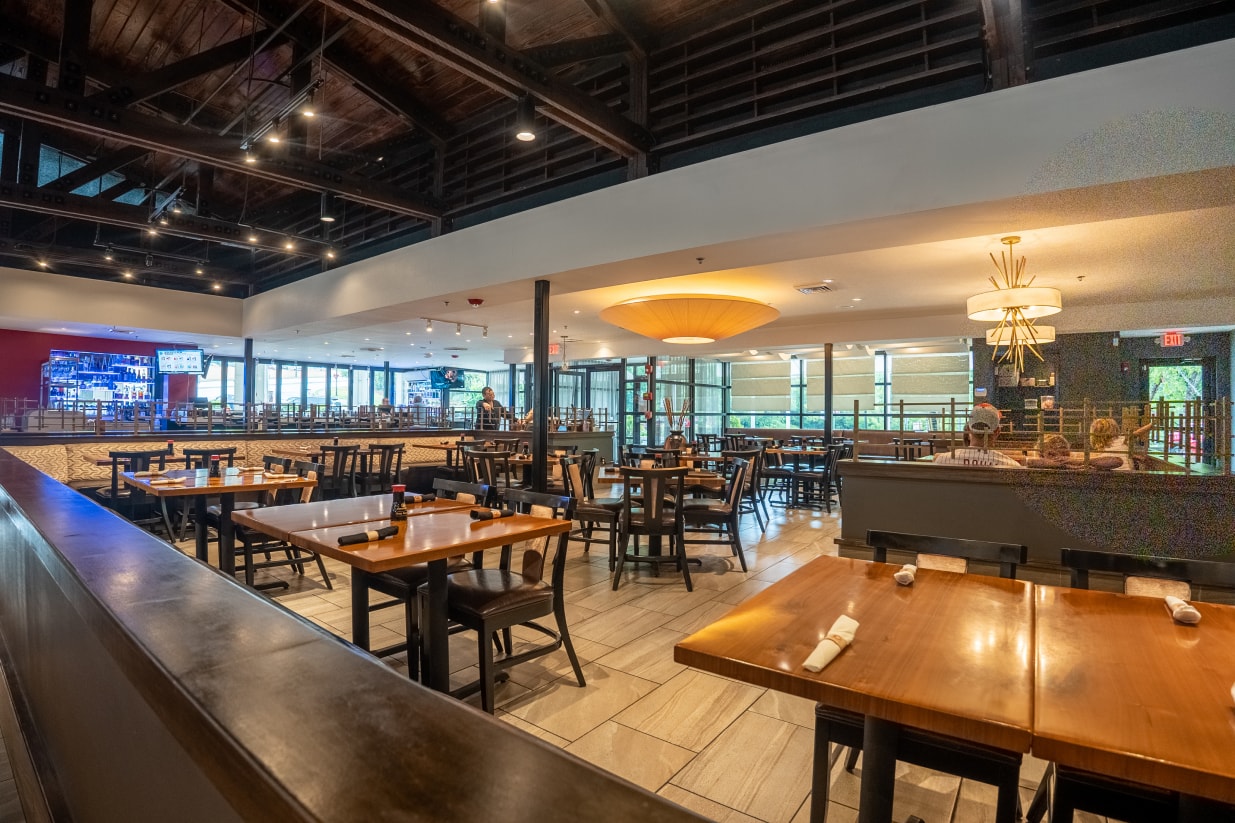 The main dining room seen from the bar, under the restaurant's exposed-beam ceiling