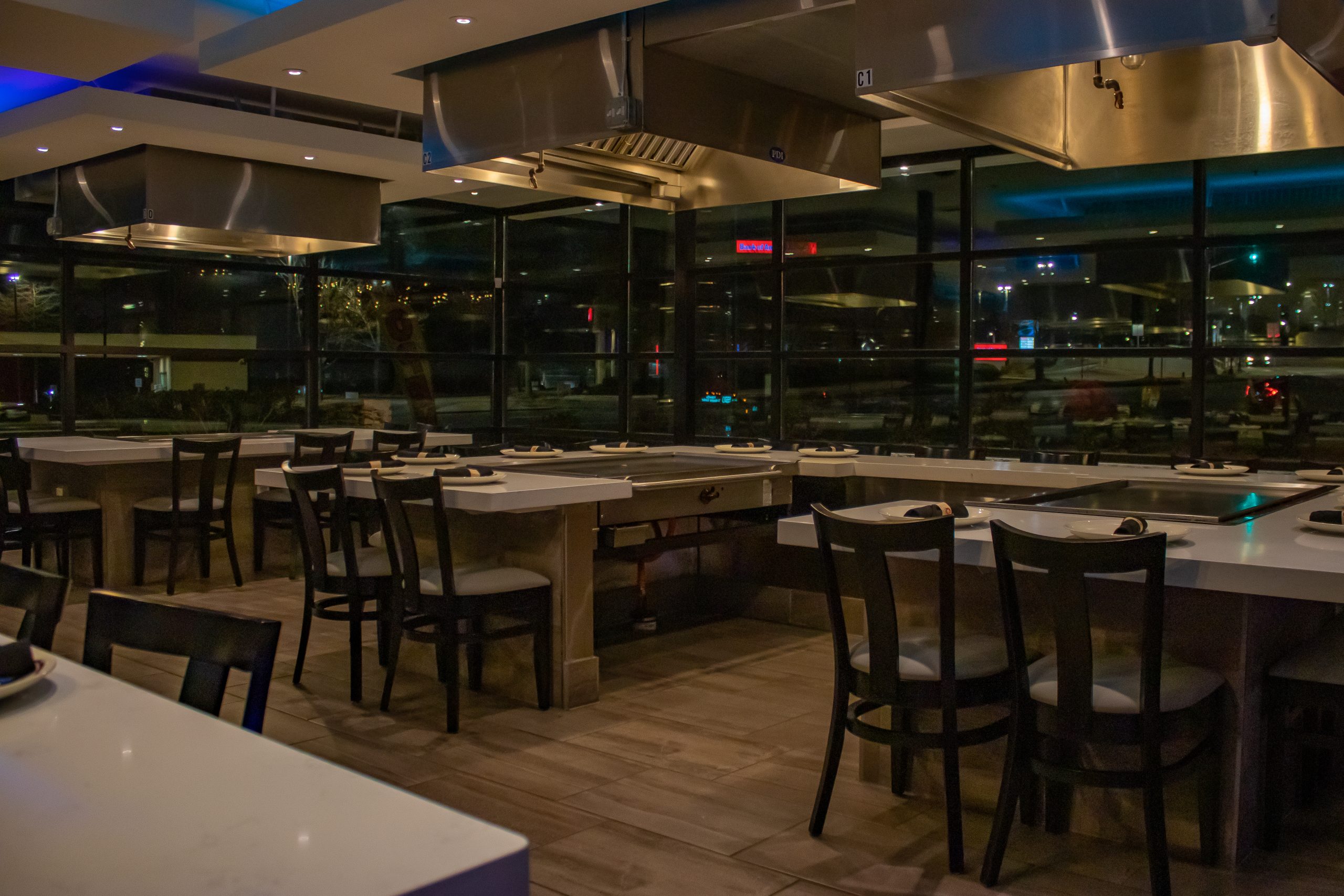 The hibachi room at night, with the city lights through the windows